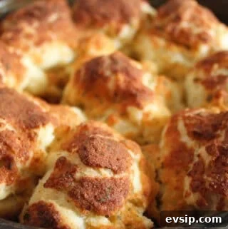 up close shot of gluten free parmesan rolls in a baking pan.