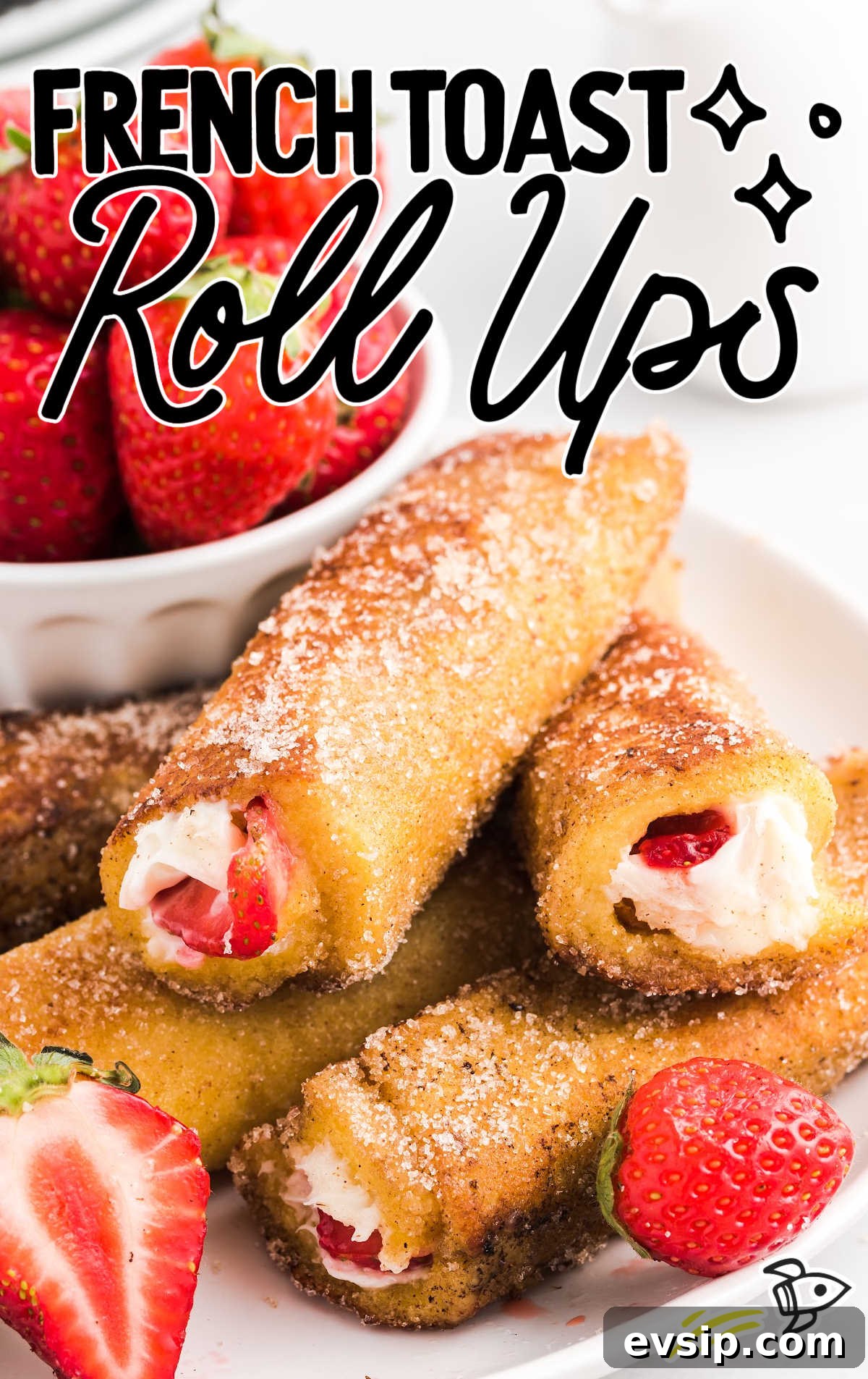 Cinnamon French Toast Roll-Ups with Maple Dipping Sauce 2 close up shot of French Toast Roll Ups with sliced strawberries on a plate