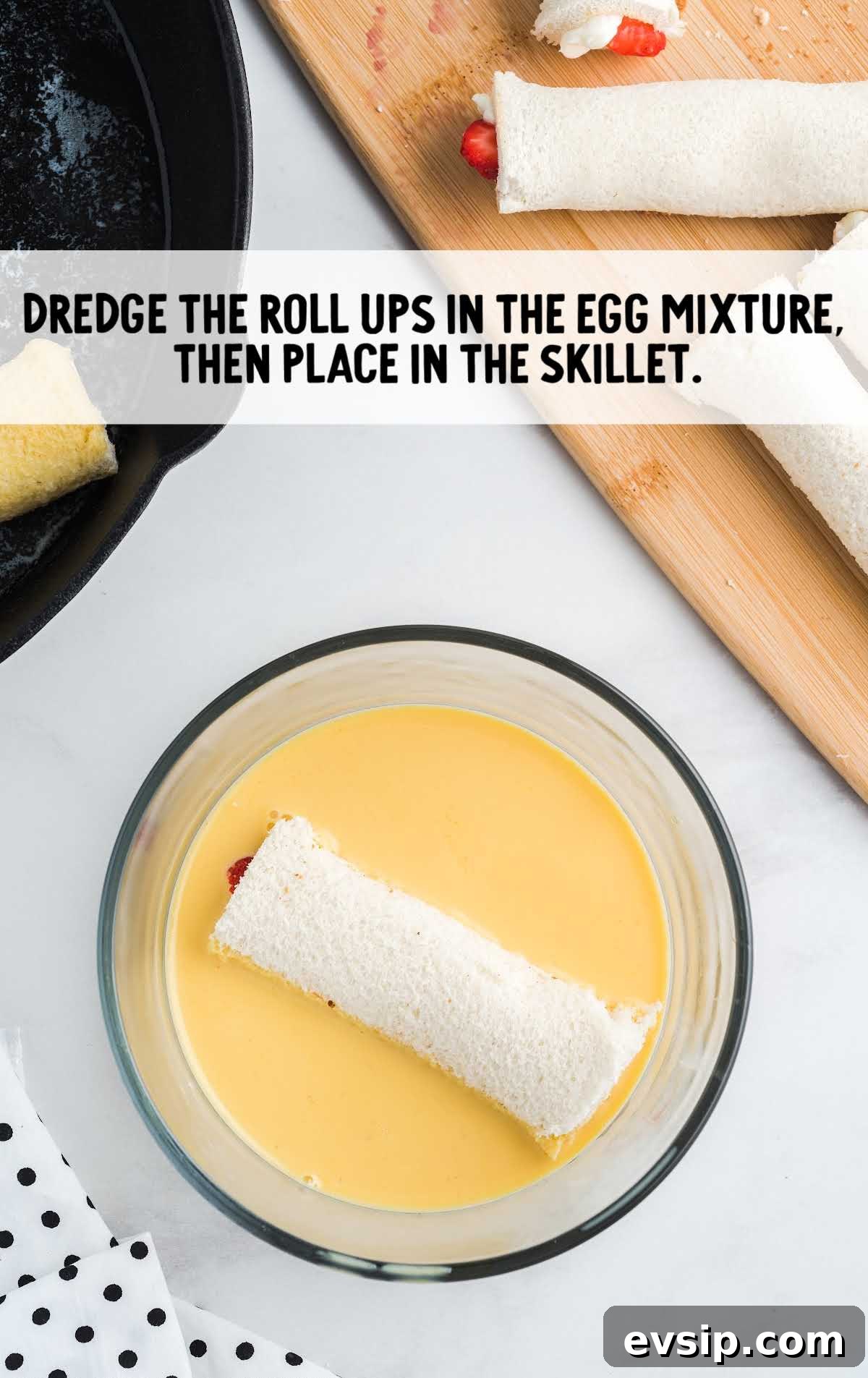 Cinnamon French Toast Roll-Ups with Maple Dipping Sauce 12 roll-ups being dredged in the egg mixture