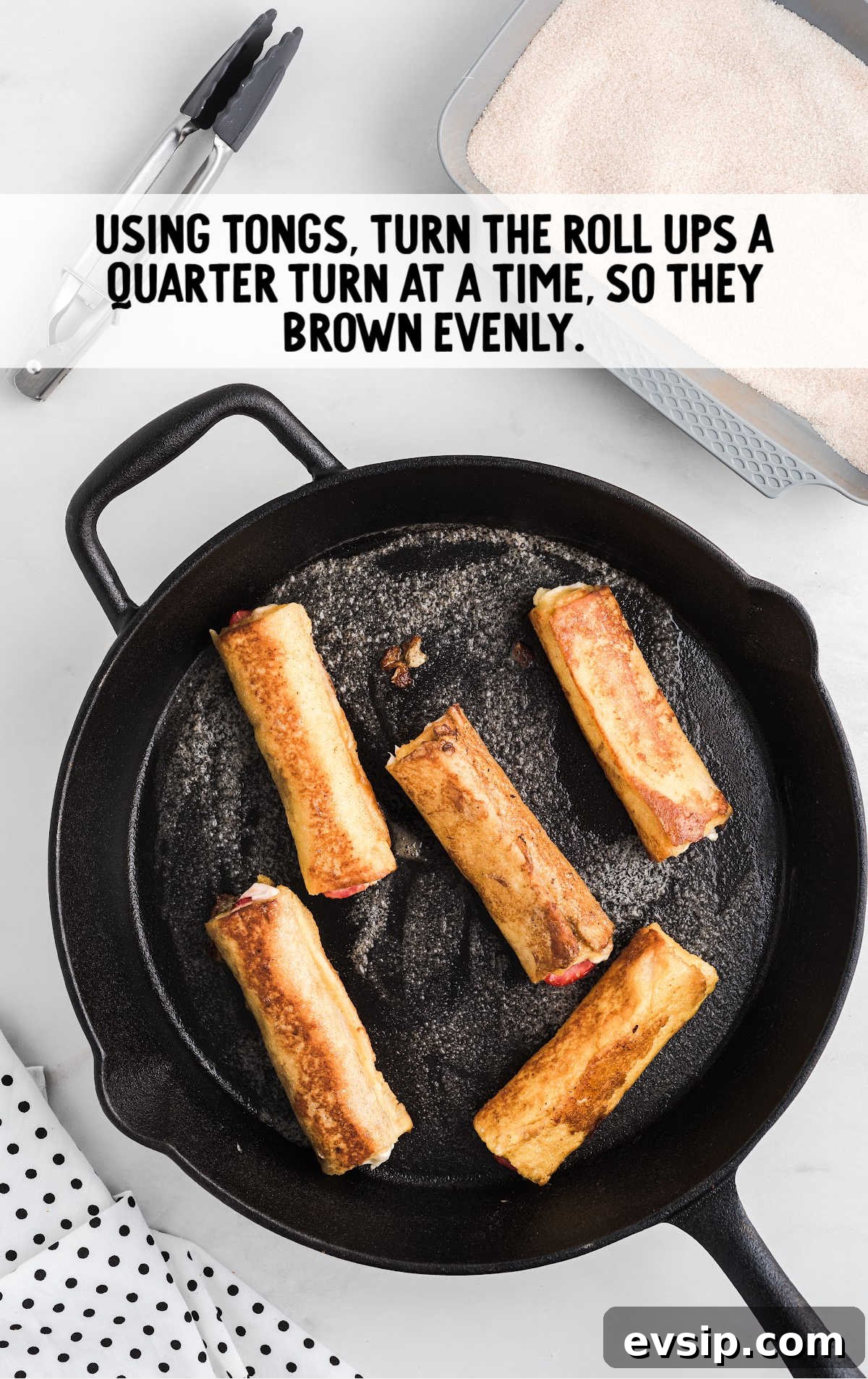 Cinnamon French Toast Roll-Ups with Maple Dipping Sauce 13 roll-ups being browned on a skillet