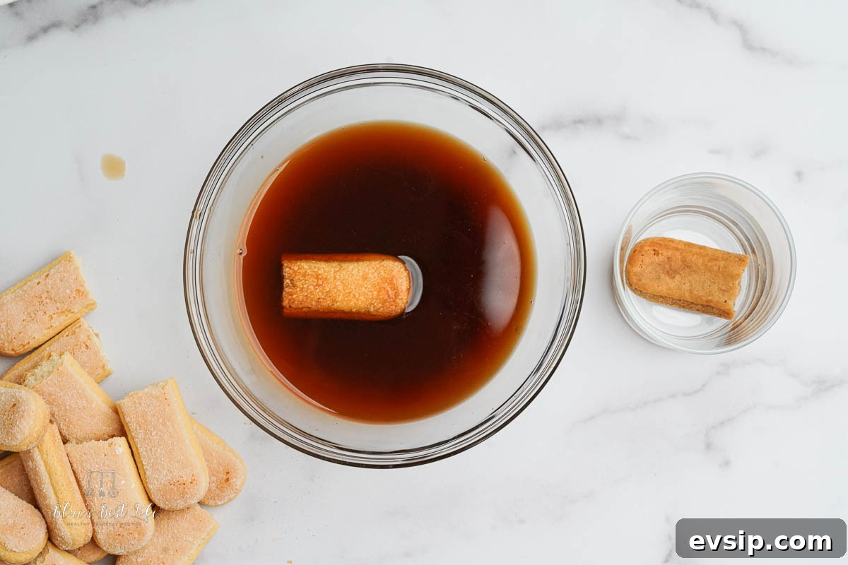 Individual Egg-Free Tiramisu Cups: Creamy No-Bake Dessert 7 soaking the lady fingers
