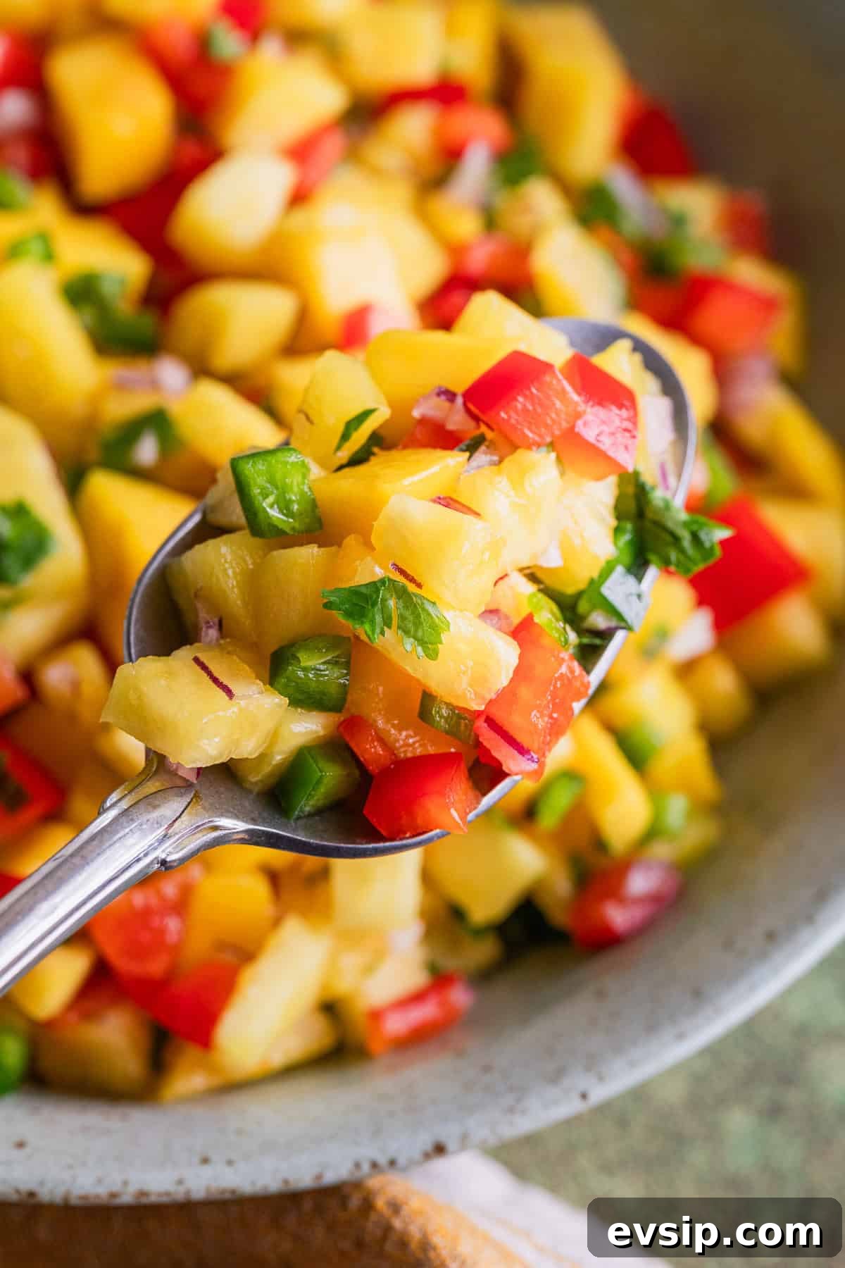 Mango Pineapple Salsa Recipe: Fresh Tropical Salsa for Chips & Fish 6 The recipe scooped on a spoon.