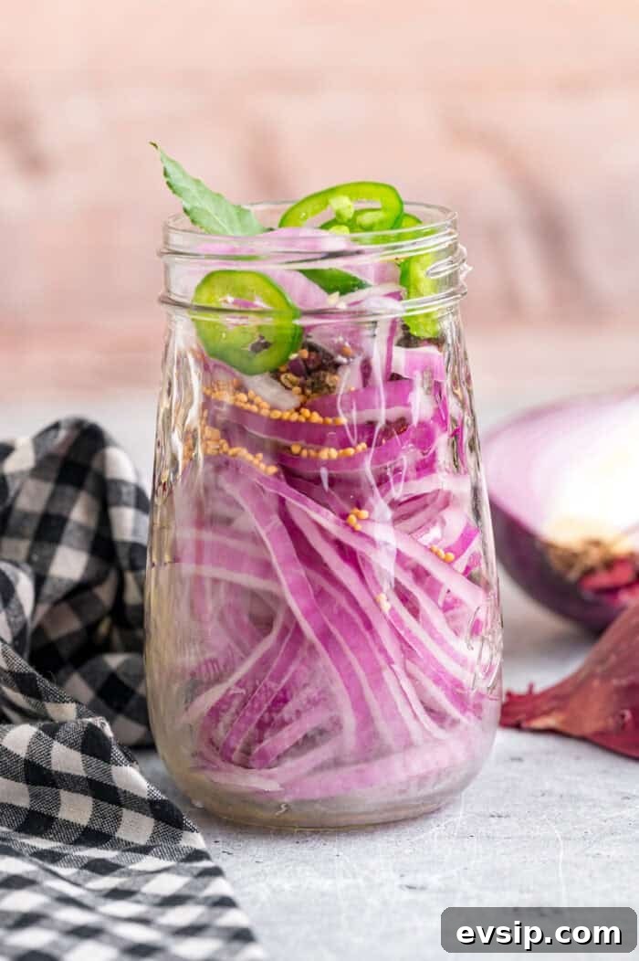 Sliced red onions and jalapenos in a jar