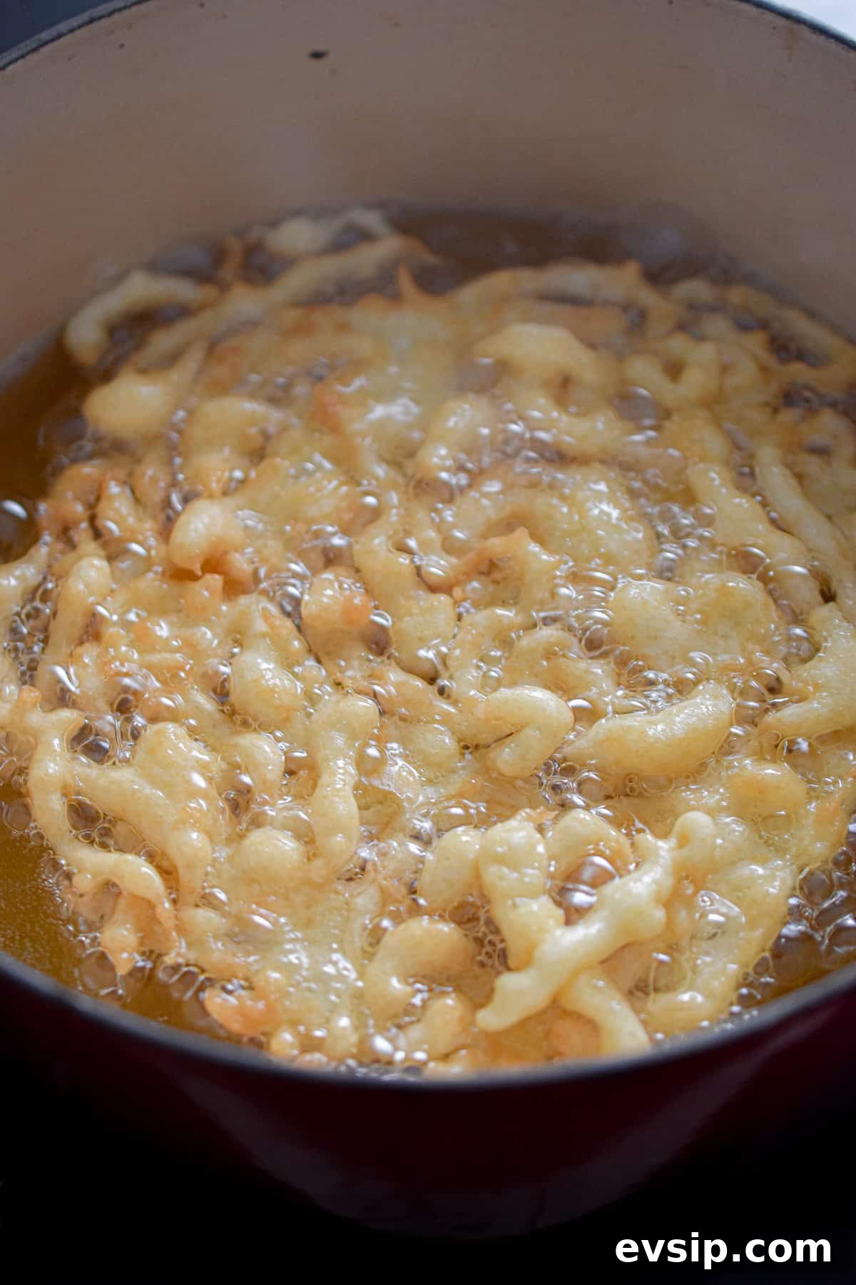 Funnel Cakes Made with Pancake Mix: Simple Fair-Style Recipe 7 The second side is being cooked.