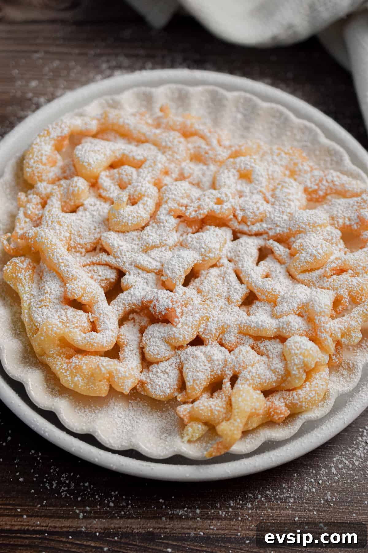 Funnel Cakes Made with Pancake Mix: Simple Fair-Style Recipe 8 The funnel cake with pancake mix is topped with powdered sugar.