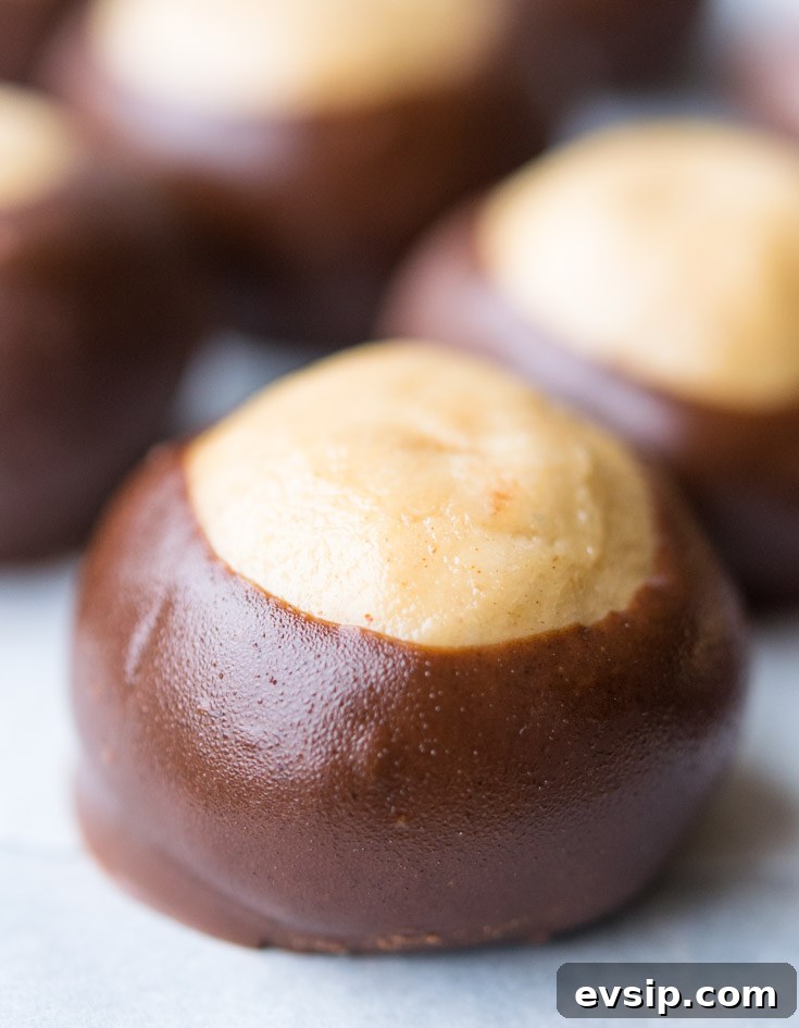Our Classic Buckeye Recipe Is The Perfect Combination Candy, Creamy Peanut Butter And Luscious Chocolate. Homemade, Easy To Make, And Amazing! Buckeye Recipe lined up on a baking sheet