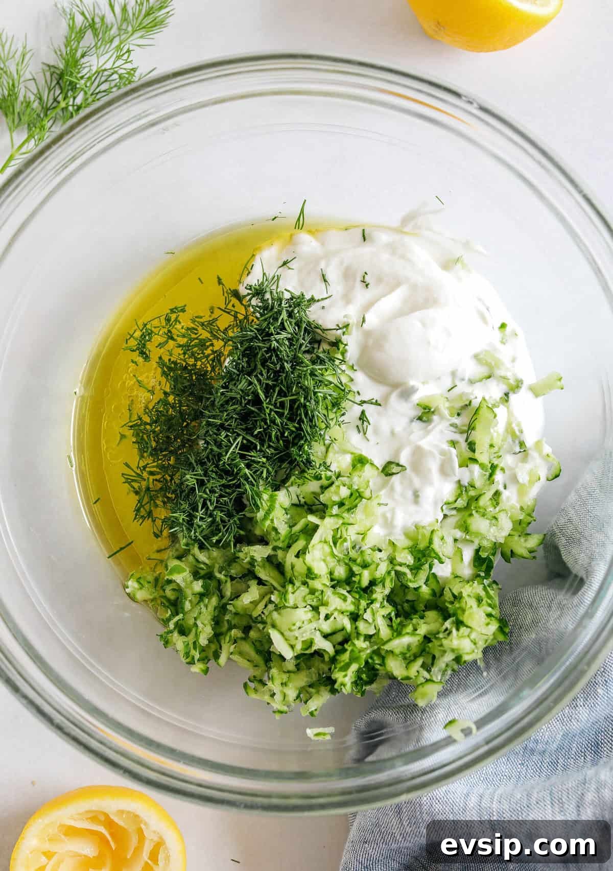 Fresh and flavorful Homemade Tzatziki Sauce is a creamy yogurt-based sauce perfect for the summer served with kabobs, grilled veggies, pita bread and more!