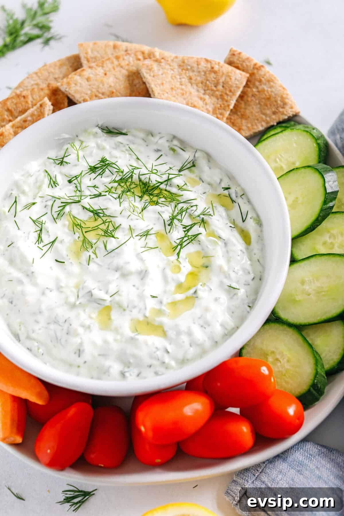 Fresh and flavorful Homemade Tzatziki Sauce is a creamy yogurt-based sauce perfect for the summer served with kabobs, grilled veggies, pita bread and more!