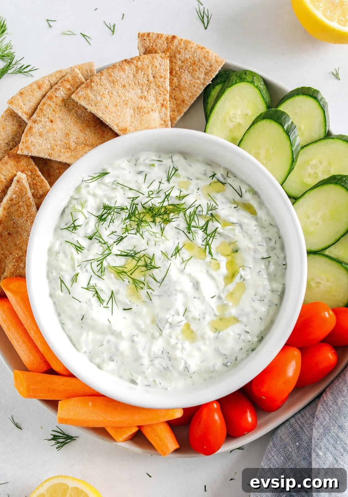 Fresh and flavorful Homemade Tzatziki Sauce is a creamy yogurt-based sauce perfect for the summer served with kabobs, grilled veggies, pita bread and more!