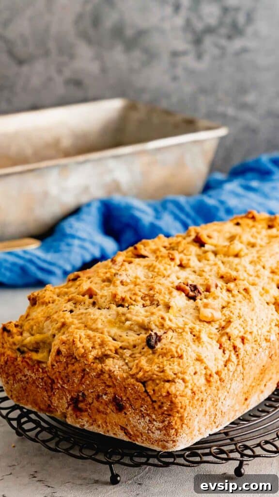 A whole loaf of Banana Nut Bread on a cooling rack.