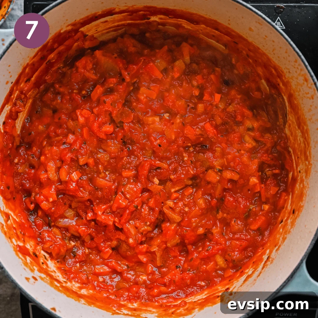 a thick and rich Italian tomato stew simmering in a dutch oven. 