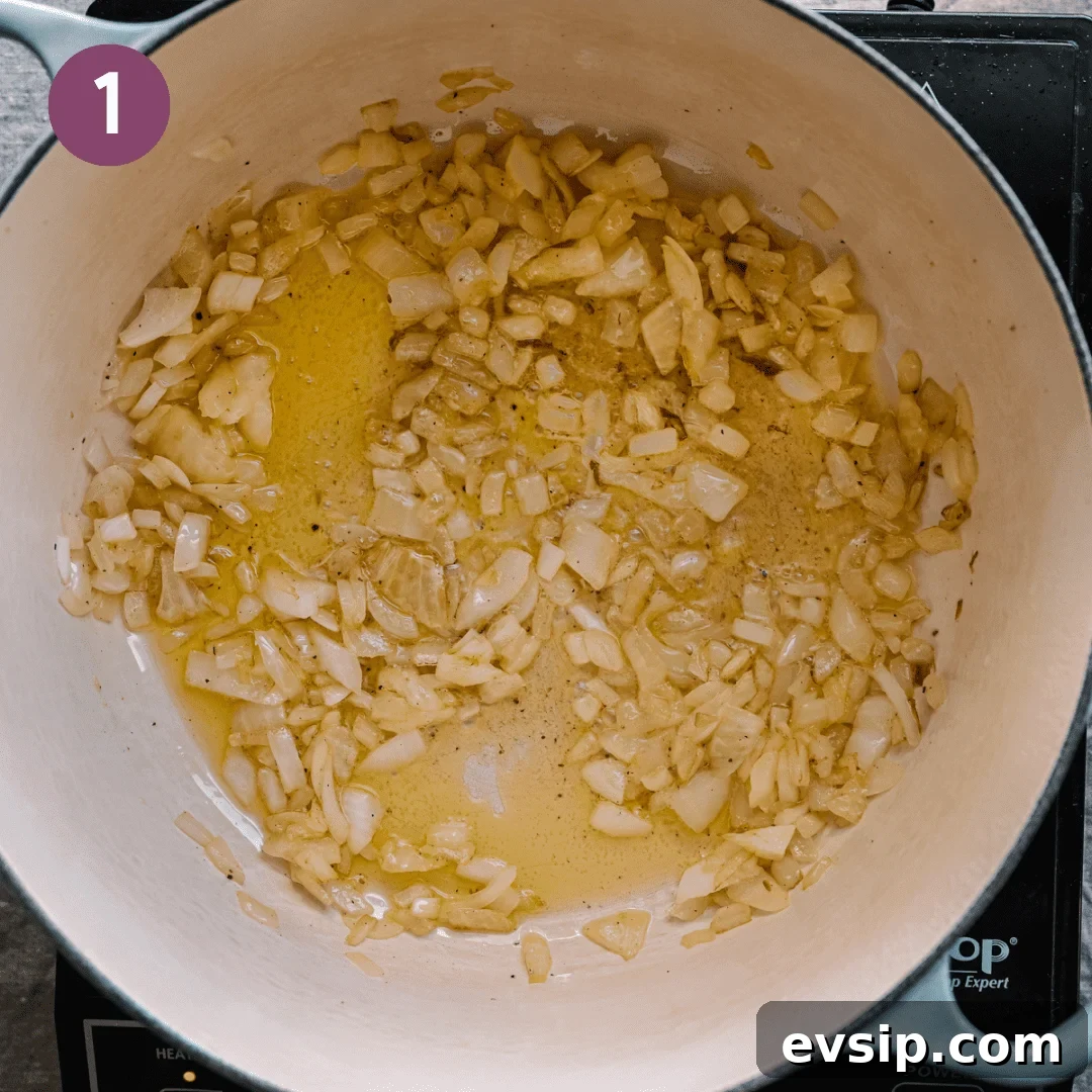diced onions sautéing in olive oil in a dutch oven.