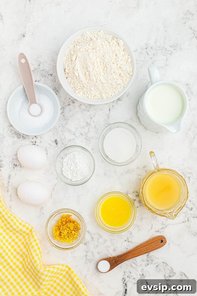 Fluffy Lemon Pancakes with Zesty Syrup Recipe 3 Ingredients measured in small bowls on a white marble table.