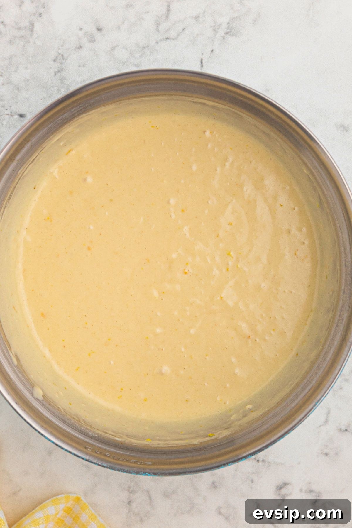 Fluffy Lemon Pancakes with Zesty Syrup Recipe 4 Pancake batter in a large clear glass bowl.