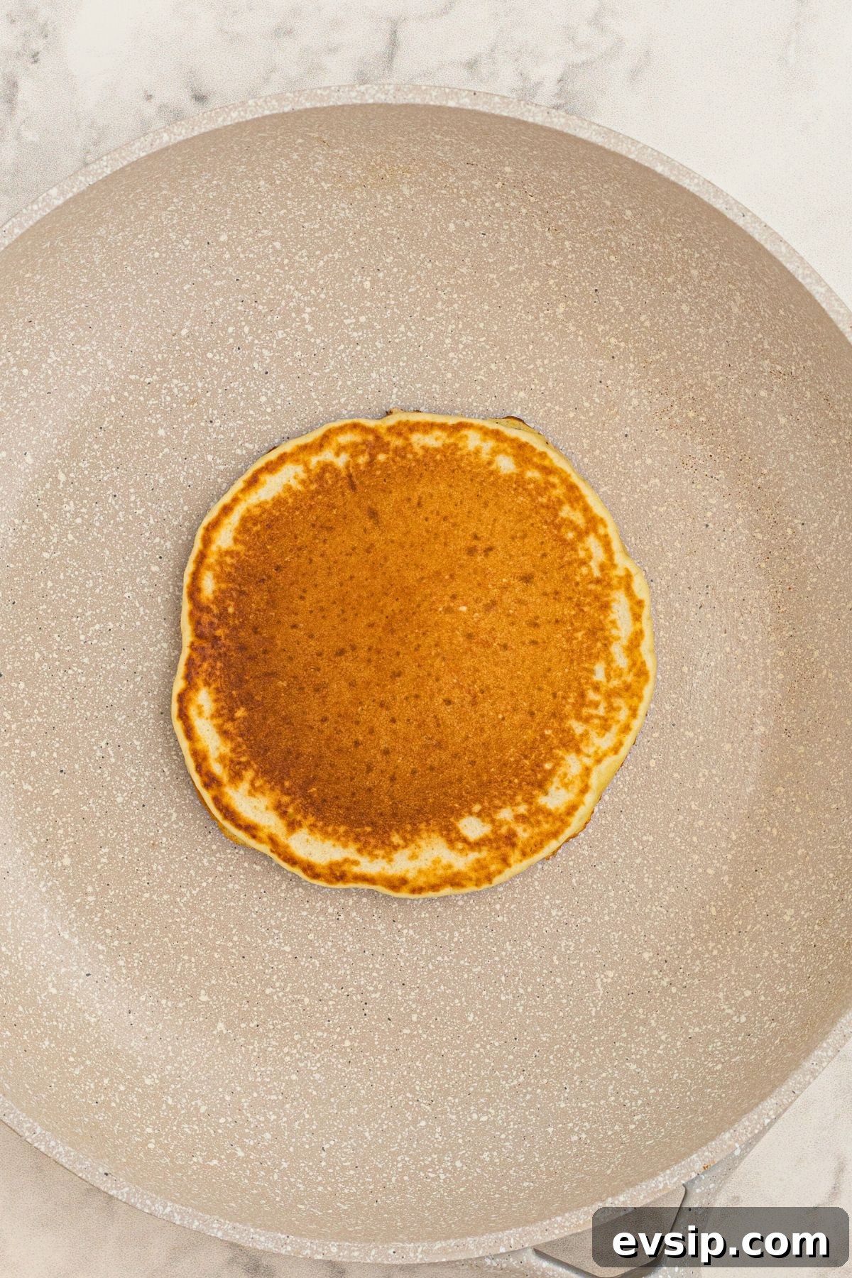 Fluffy Lemon Pancakes with Zesty Syrup Recipe 5 Golden pancake cooked in a skillet.
