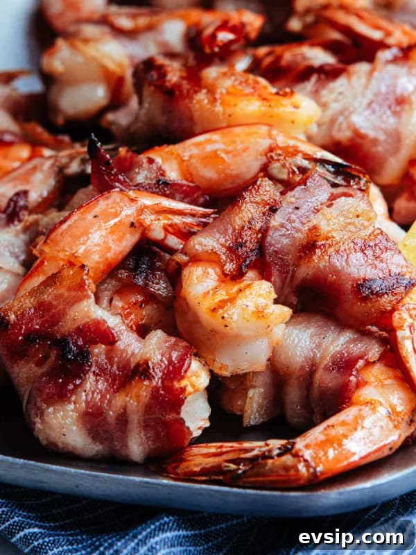 Grilled Bacon Wrapped Shrimp served on a stainless steel platter.