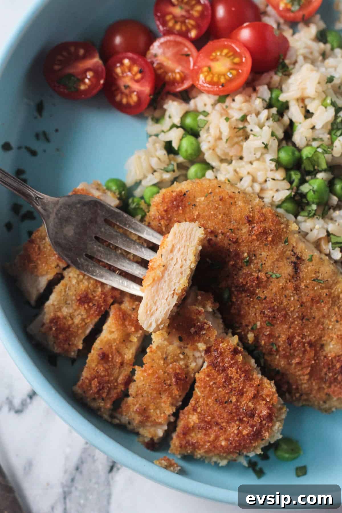 Close up of a slice of vegan chicken on a fork.