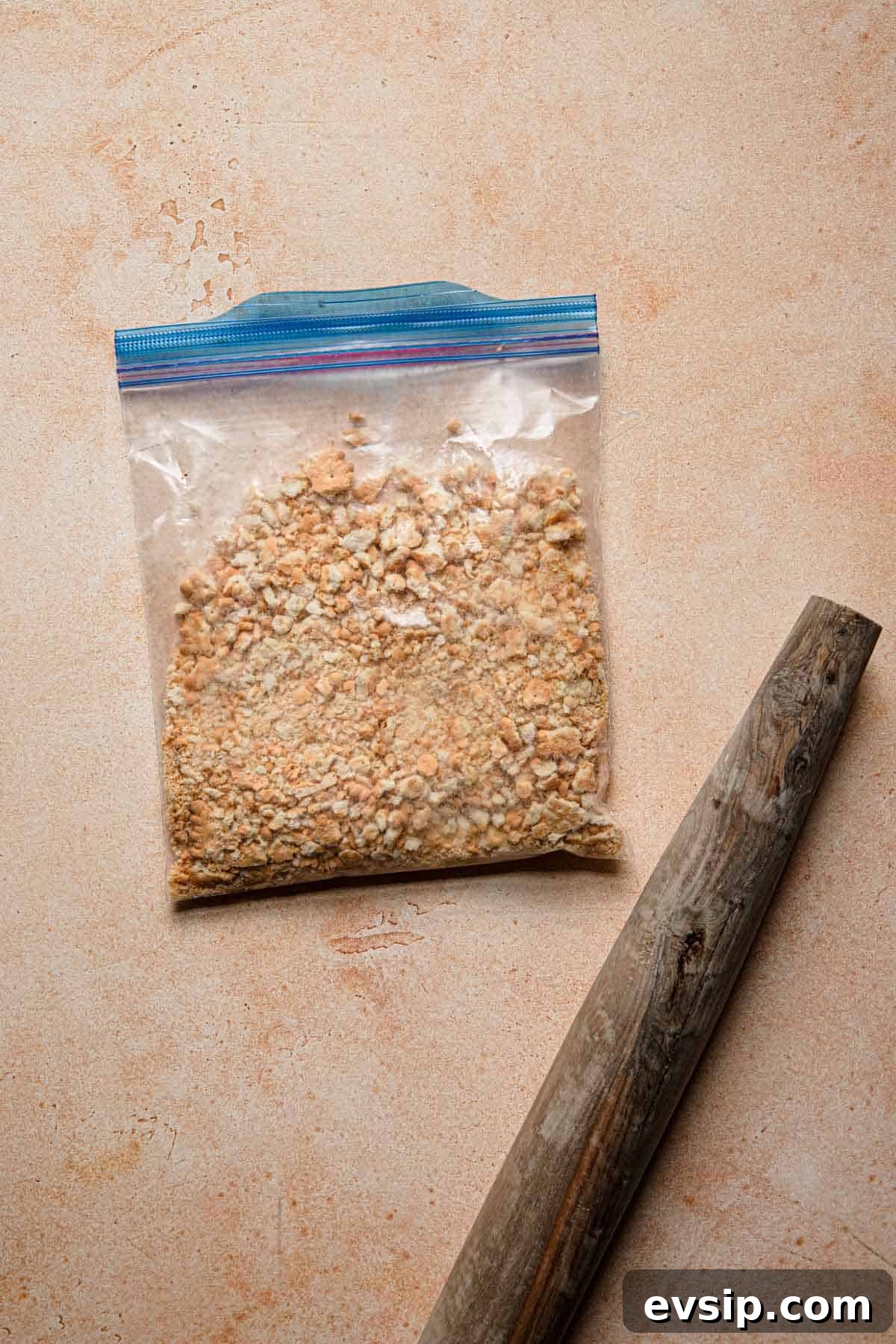 Israeli Chocolate Truffles Recipe — Classic No-Bake Treat 3 Crushed cookies in a bag and a rolling pin next to it.