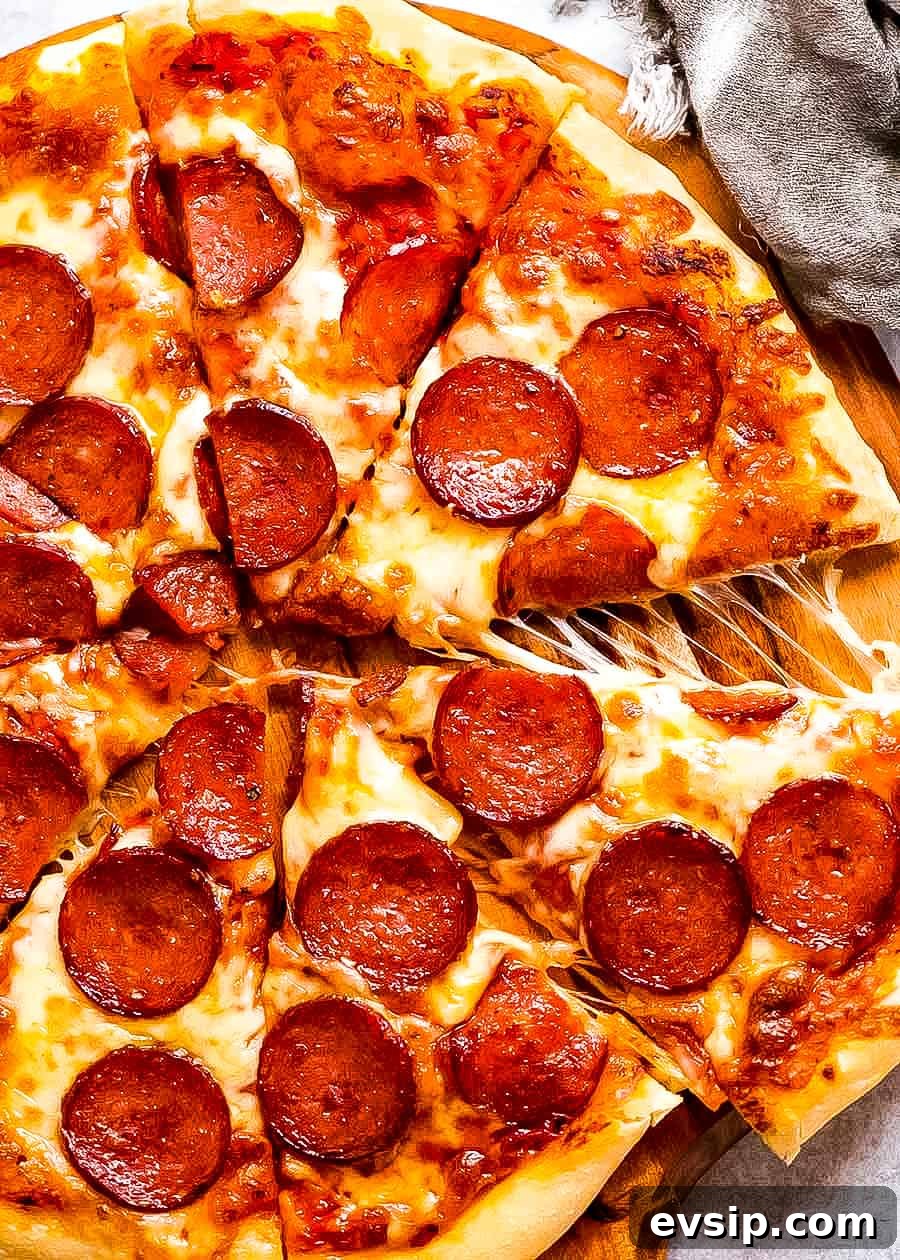 A sliced pepperoni pizza with a piece being pulled off. 