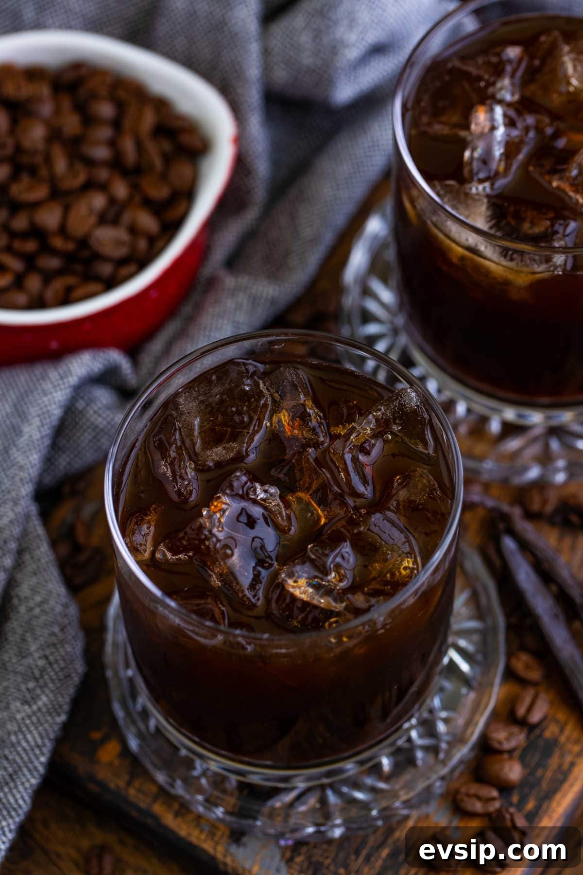 Homemade Kahlúa Liqueur Recipe: How to Make Coffee Vodka Liqueur 7 A glass of the recipe on a wooden surface.