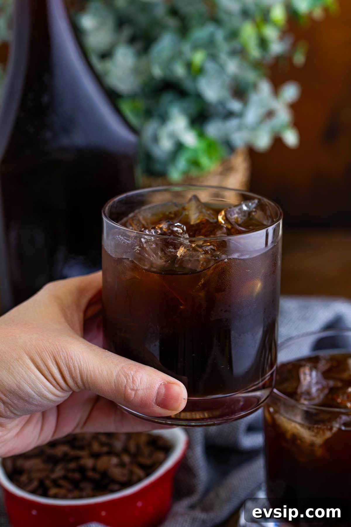 Homemade Kahlúa Liqueur Recipe: How to Make Coffee Vodka Liqueur 8 A hand holding a glass of the recipe.