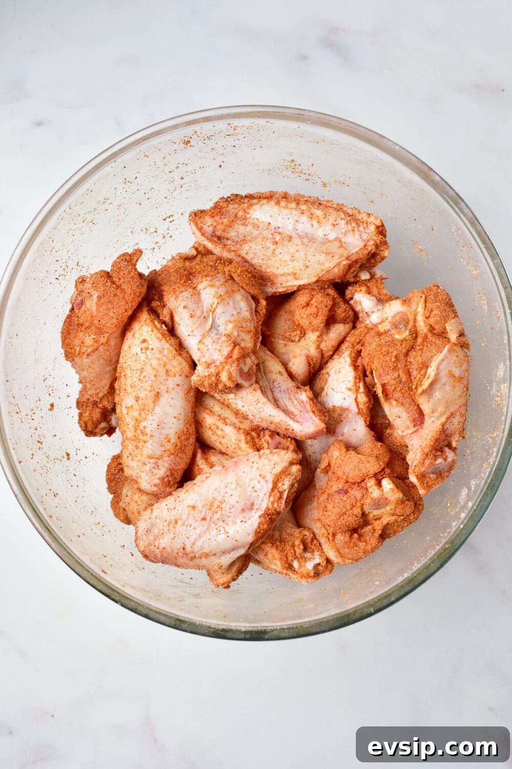 coated raw chicken wings with spices