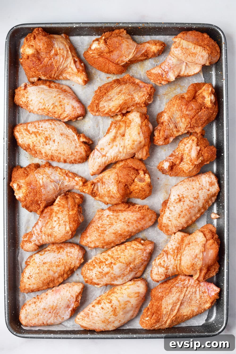 coated chicken wings on a baking pan