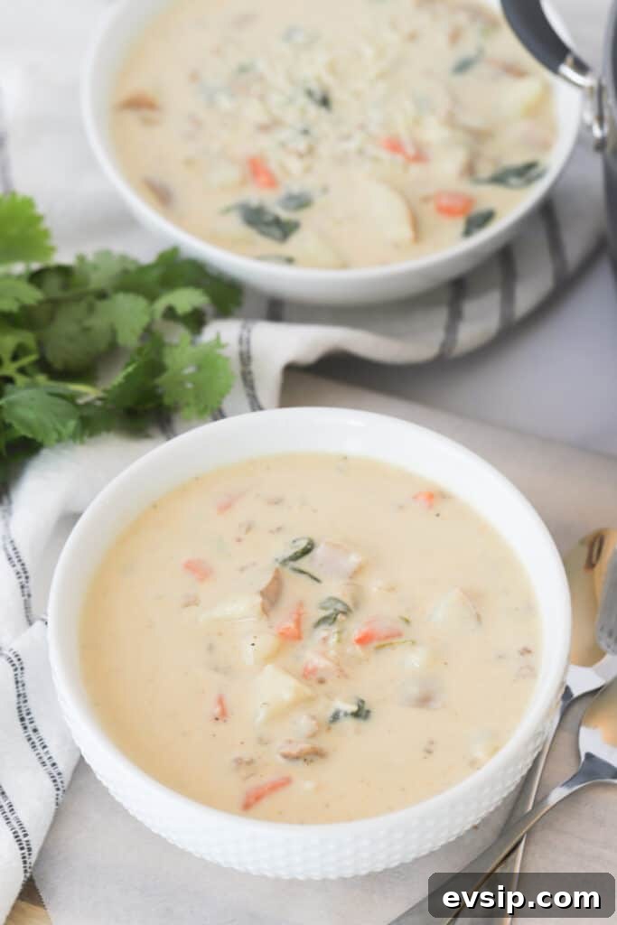 Tuscan Soup with sausage and vegetables in a serving bowl, an authentic zuppa toscana recipe that is just like the olive garden tuscany soup.