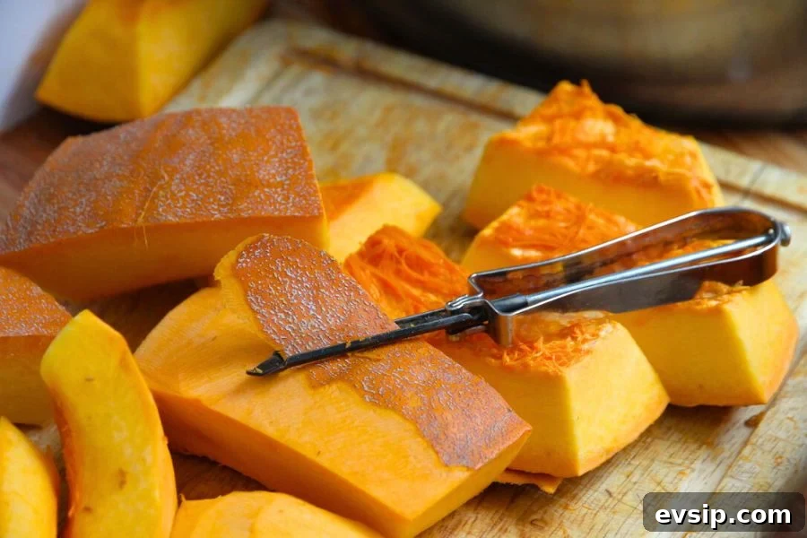 Slices of pumpkin being peeled with a vegetable peeler.