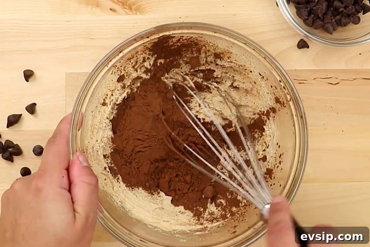 Chewy Chocolate Chip Brookie Recipe: Brownie-Cookie Mashup 5 Whisked the melted butter with both sugars, then added in the cocoa powder in a medium bowl.