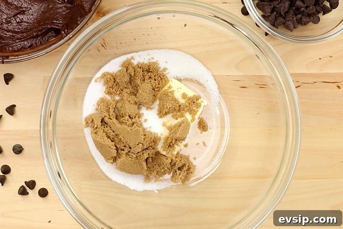 Chewy Chocolate Chip Brookie Recipe: Brownie-Cookie Mashup 7 Softened butter with brown sugar and granulated sugar in a bowl.