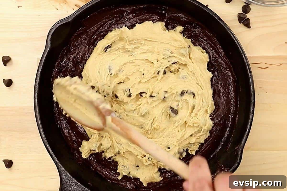 Chewy Chocolate Chip Brookie Recipe: Brownie-Cookie Mashup 10 Spreading the brownie batter evenly into the prepared skillet.