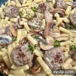 A bowl of meatballs, mushrooms and pasta