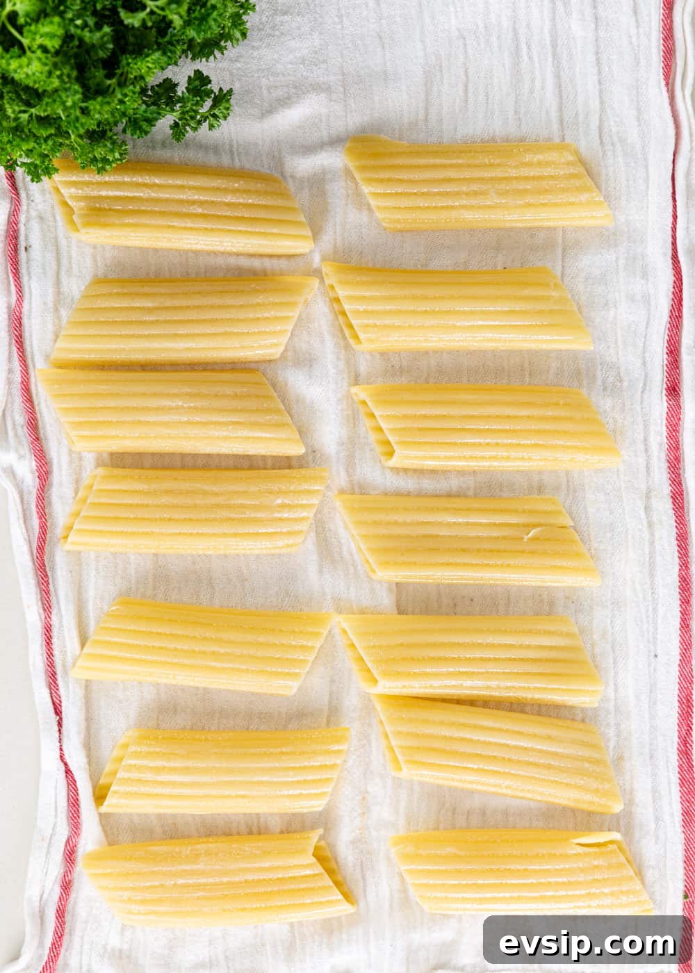 Cheesy Beef Manicotti Recipe with Homemade Marinara 4 overhead process shot: cooked manicotti noodles on a towel