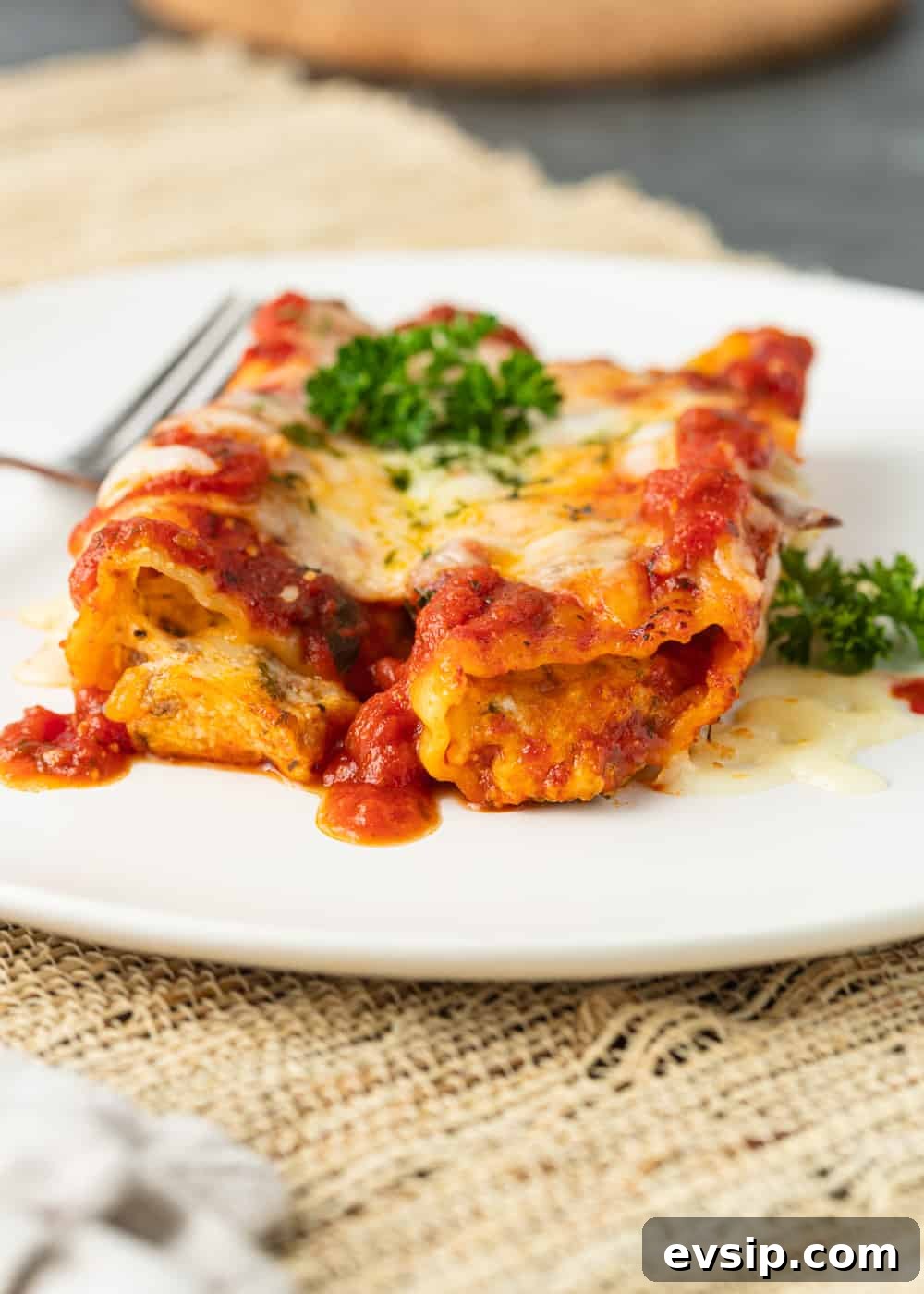 Cheesy Beef Manicotti Recipe with Homemade Marinara 7 my manicotti recipe on a plate with sauce and melted cheese
