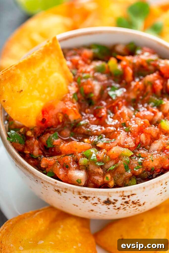 Fresh restaurant-style Mexican Salsa served in a bowl with Tortilla Chips