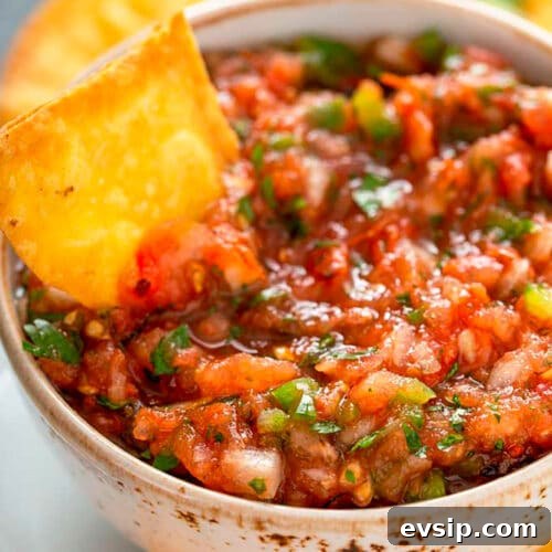 Fresh restaurant-style Mexican Salsa served in a bowl with Tortilla Chips