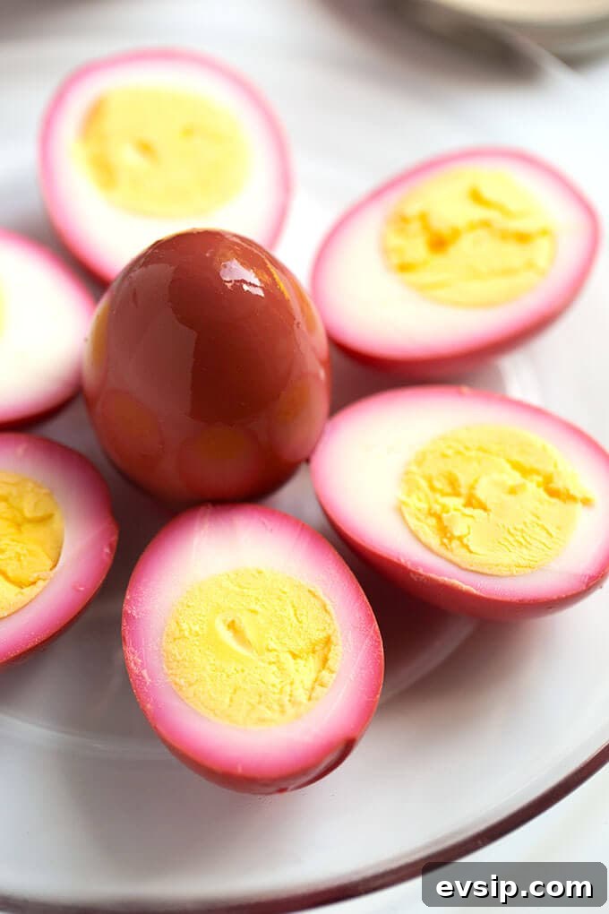 Quick Tangy Pickled Beets Recipe for Homemade Jars 4 Halved pickled eggs on white plate with yoke side up