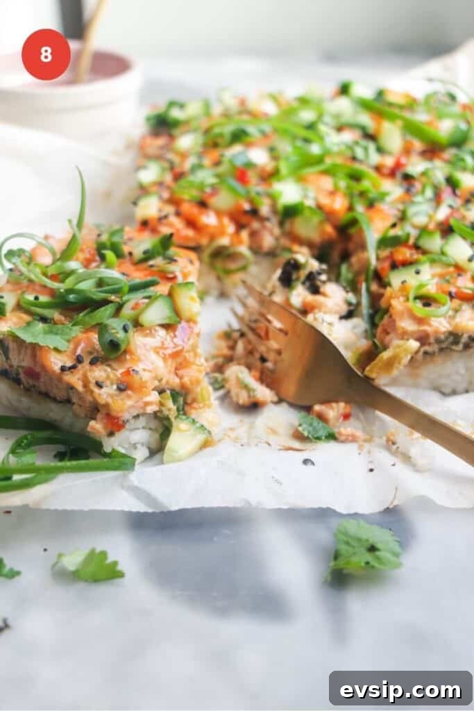 Salmon sushi bake sliced with a fork.