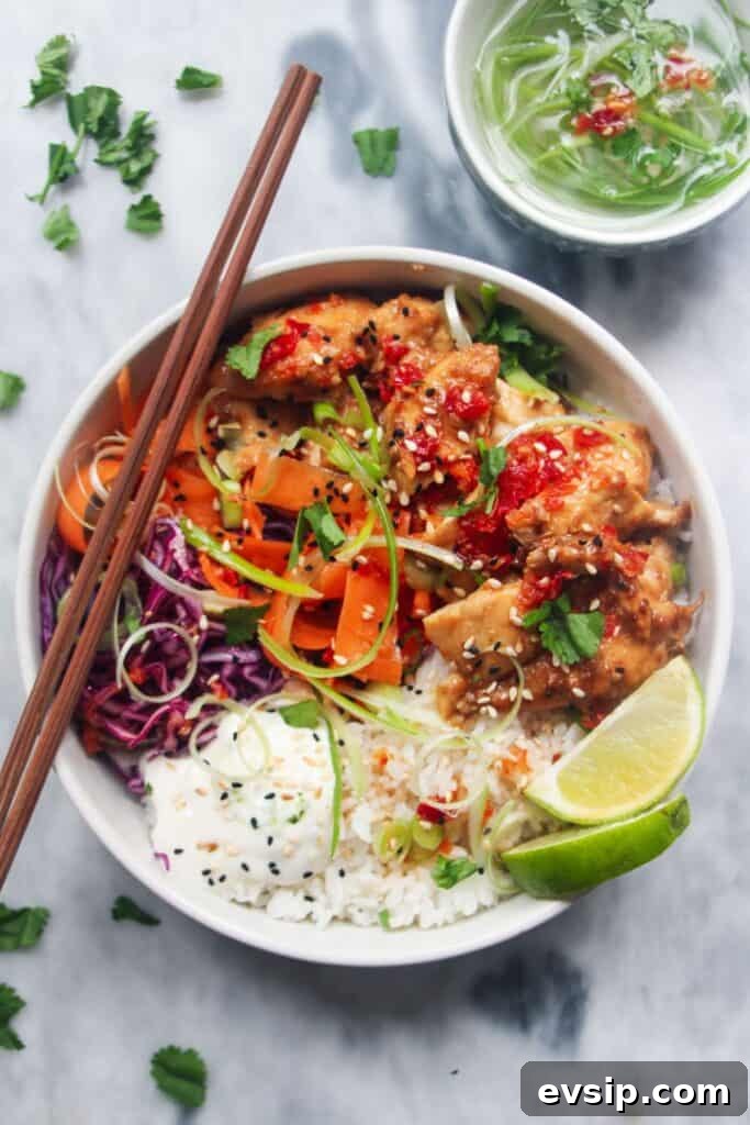 Grilled chicken poke bowl on a grey marble background.