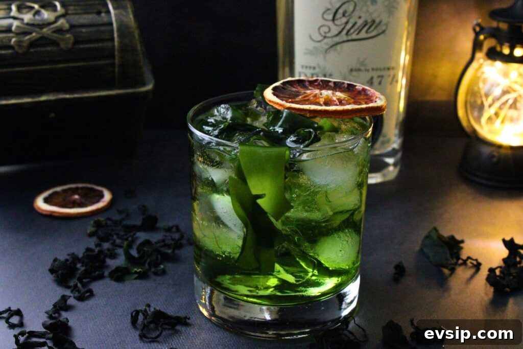 flying dutchman cocktail in front of gin bottle and pirate chest