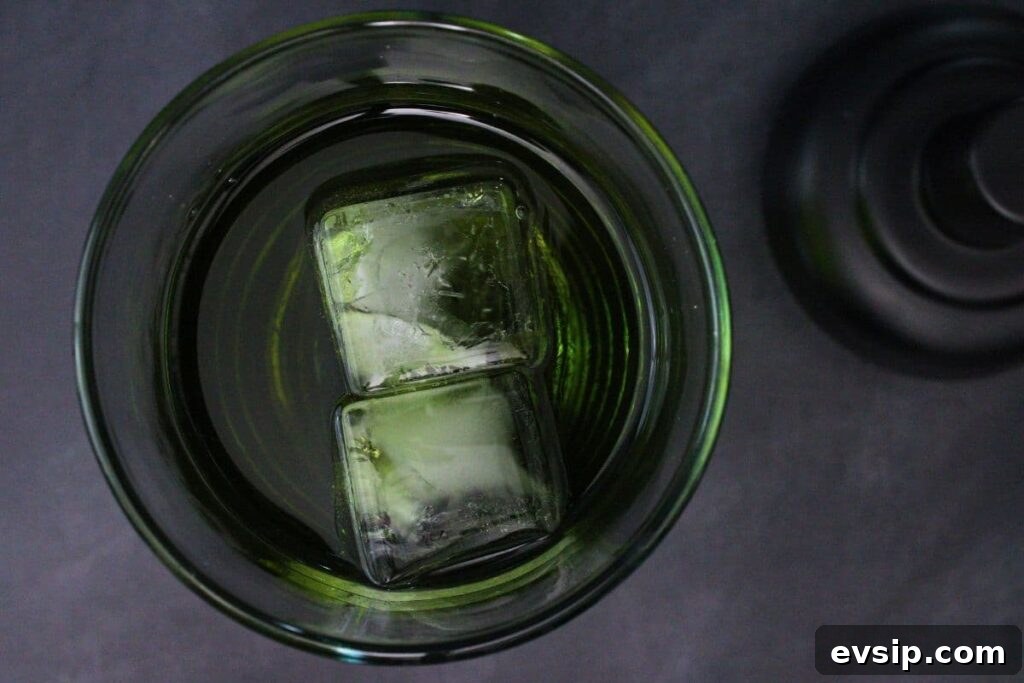 add gin, triple sec, apple liqueur, and apple juice to a cocktail shaker