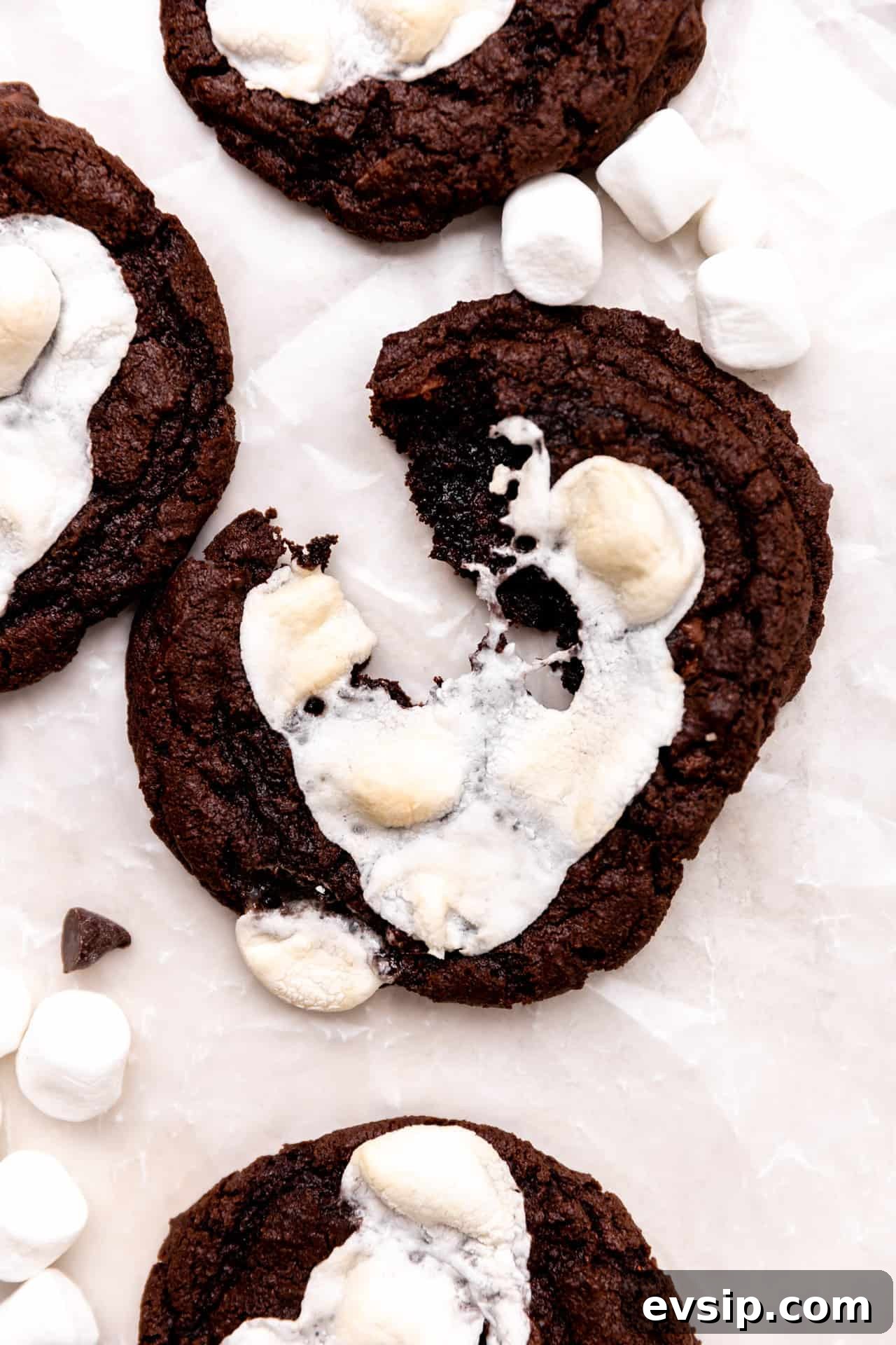 Mexican hot chocolate cookies with marshmallows being split apart.