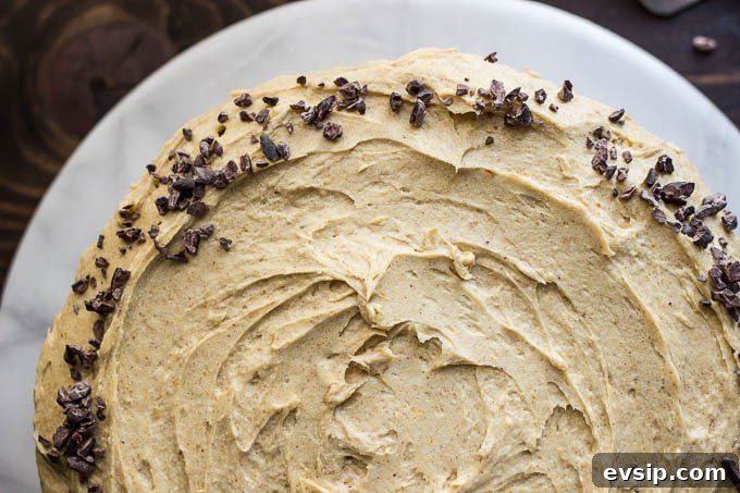 Chocolate Cake with Pumpkin Spice Frosting Recipe & Tips 4 frosted cake topped with cacao nibs