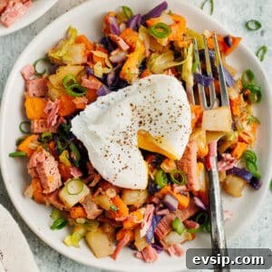 Corned Beef Hash and Poached Eggs Breakfast Recipe 14 This is a picture of corned beef hash topped with a poached egg.