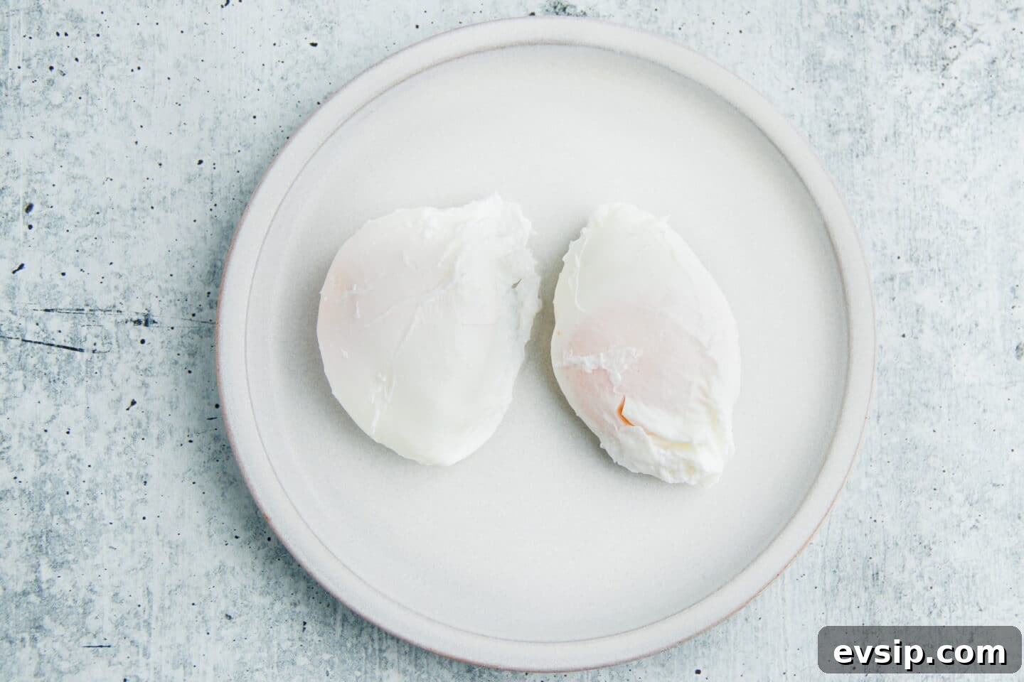 Corned Beef Hash and Poached Eggs Breakfast Recipe 7 This is a picture of two poached eggs on a plate.