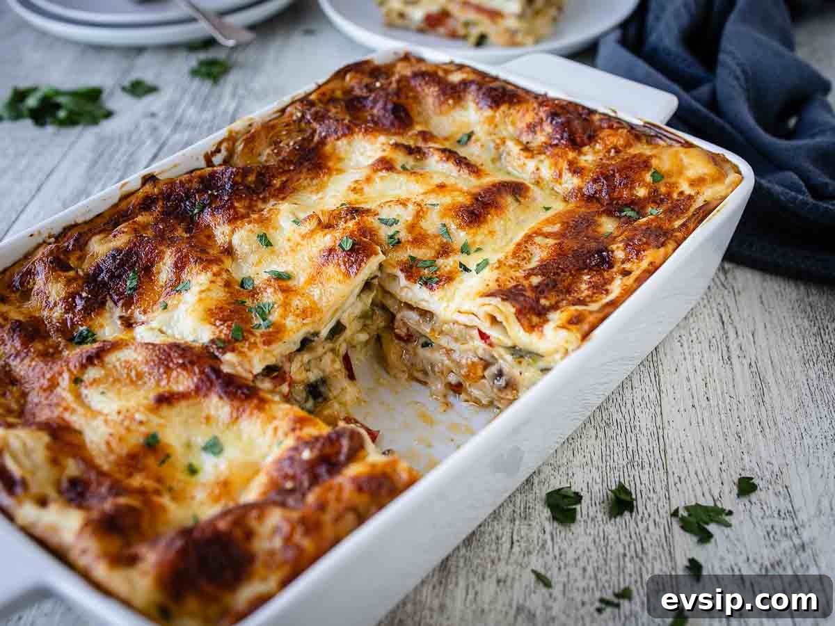 Lasagna in a rectangle dish with a piece cut out.