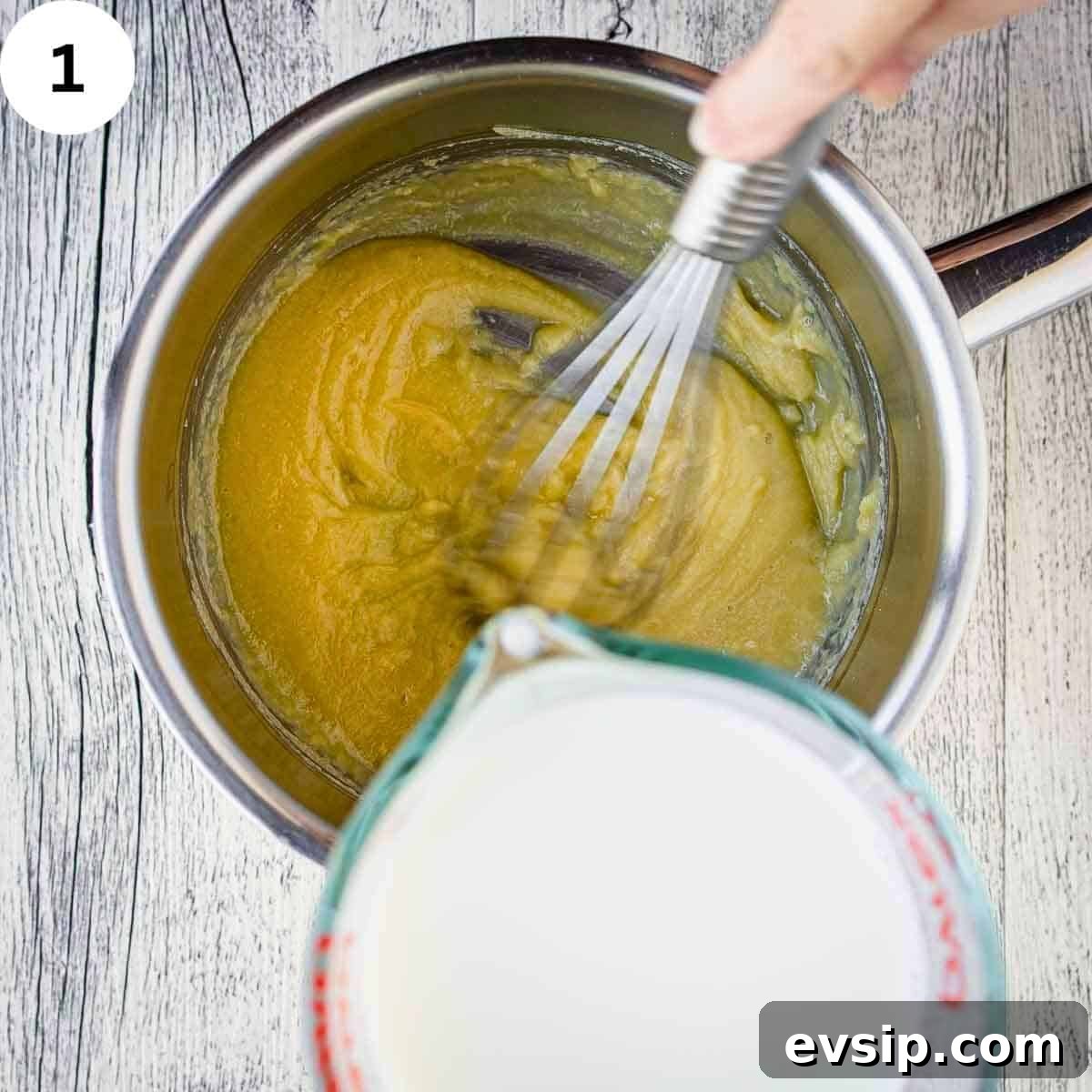 Adding milk to yellow mixture in a saucepan.