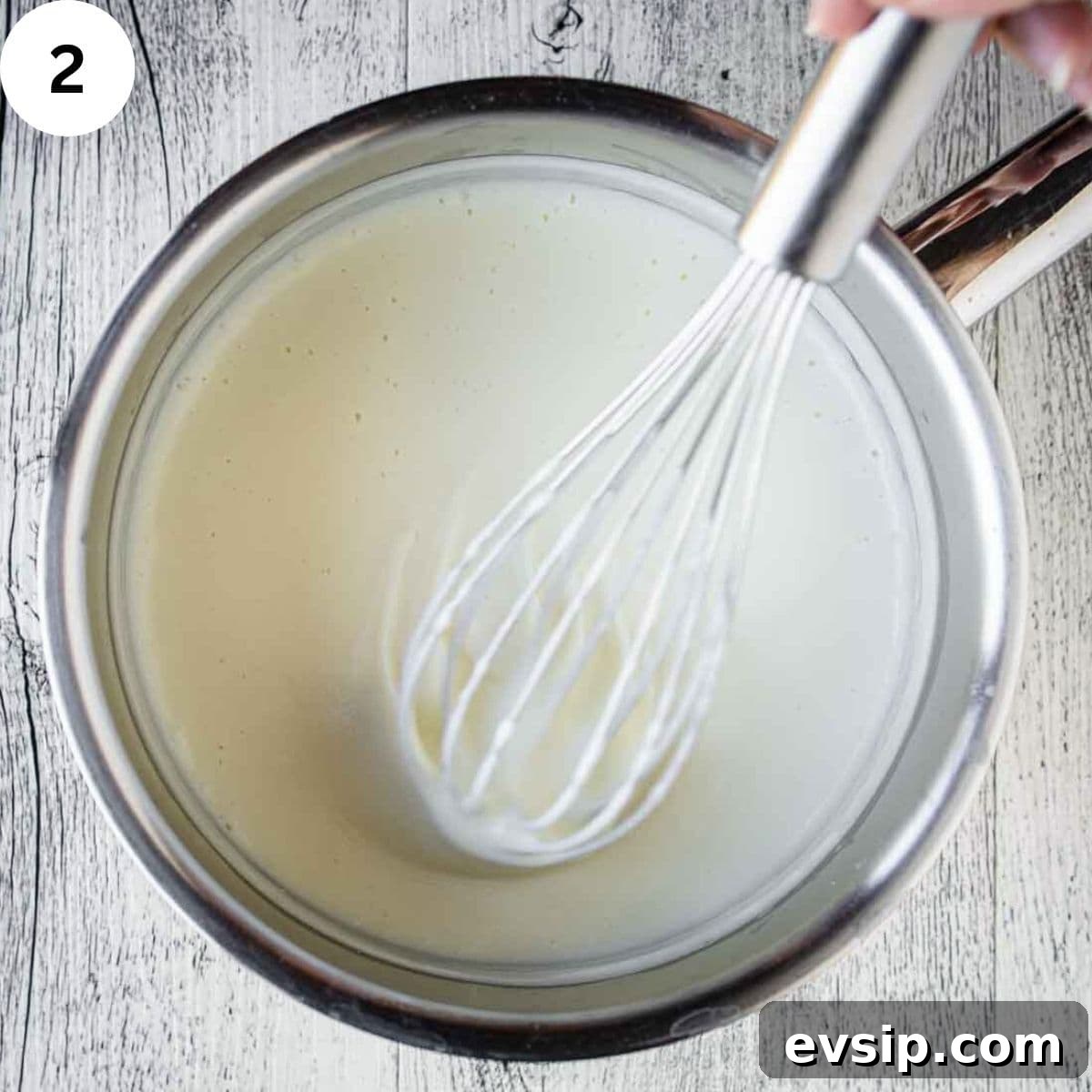 Whisking a creamy, white sauce.