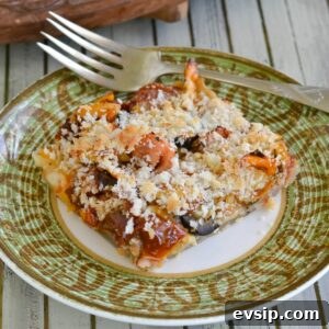 Roasted Heirloom Tomato and Ham Tart Recipe 3 A wedge of heirloom tomato and ham tart on a plate.